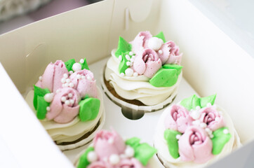 Tender cake with whipped cream. Cake in the form of flowers. Cupcake with whipped cream.