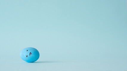 Exhausting lifestyle. Conceptual banner. Stress fatigue. Loneliness depression. Blue color tired egg with dizzy face lying with tongue out isolated on light conceptual empty space background.