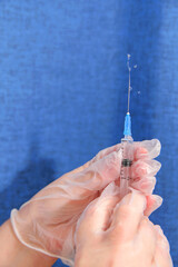 Nurse lets air out of syringe with medicine flowing.