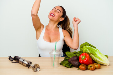 Young caucasian woman preparing a healthy smoothie with vegetables