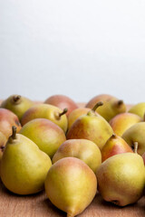 Homegrown organic pears grouped together against a white backdrop