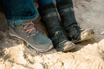 Feet shod in shoes on the sand
