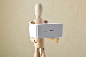Wooden Figure Holding “Skill Set” Box
