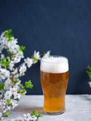 A glass of beer, cherry blossom branches