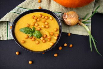 orange tasty pumpkin soup on the dark background - obrazy, fototapety, plakaty