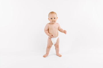 Smiling child standing on white studio background