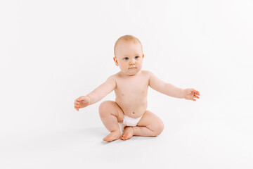 Funny little baby wearing diaper playing on white background