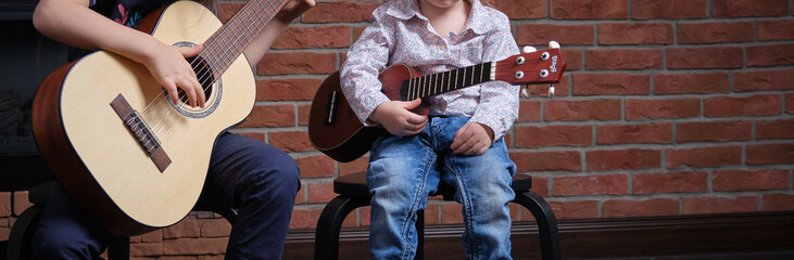 Learning to play the guitar. Music education and extra-curricular lessons.