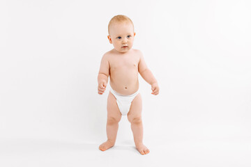 Smiling child standing on white studio background