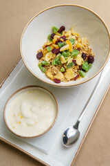 Plates with muesli and yogurt on the table. Oatmeal with fruit and yogurt. Healthy eating. Light and tasty breakfast. Diet