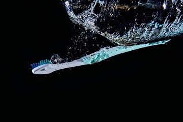 toothbrush falls into water and makes air bubbles