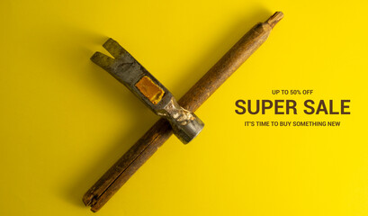 A broken hammer on a yellow background. Cool banner for DIY advertising super sale.