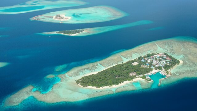 Bird's eye view of tropical islands in the ocean. View of the islands from a drone. Maldives, Thinadhoo (Vaavu Atoll), Dhigurah
