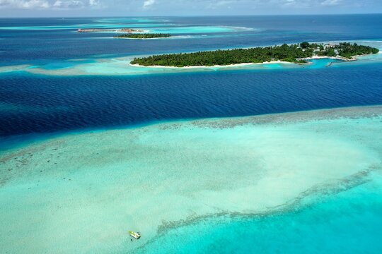 Bird's eye view of tropical islands in the ocean. View of the islands from a drone. Maldives, Thinadhoo (Vaavu Atoll), Dhigurah