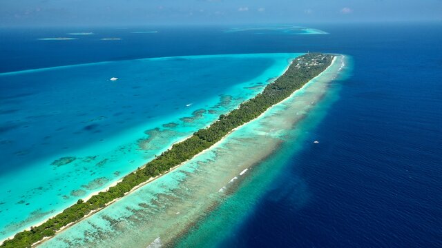 Bird's eye view of tropical islands in the ocean. View of the islands from a drone. Maldives, Thinadhoo (Vaavu Atoll), Dhigurah