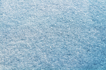 Fresh snow texture in blue tone. Winter background.