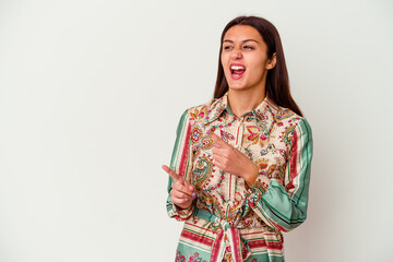 Young Indian woman isolated on white background pointing with forefingers to a copy space, expressing excitement and desire.