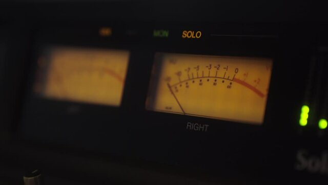 Analog Vintage Dial Indicator of Sound Signal Level. Arrow moves in sync with sound level. Close-up. Classic vintage volume indicator working Reel to reel VU meters. Volume indicator needles moving