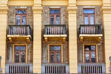 Facade of a yellow building. The building was built in the Stalinist Empire style.
