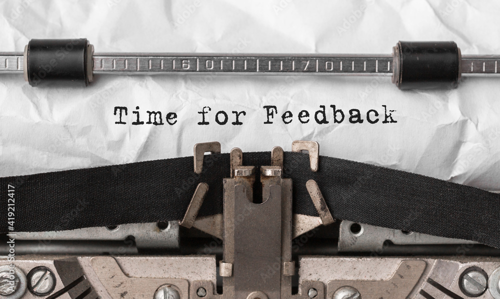 Fototapete text time for feedback typed on retro typewriter