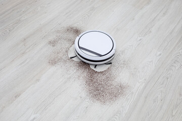 Robot vacuum cleaner cleaning household dirt. Automatic floor cleaning. Smart home concept....