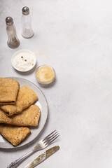Pancakes on a plate on a light background