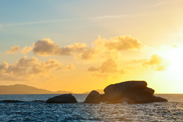 Fototapeta na wymiar Wonderful Sunset over the sea with island in silhouette