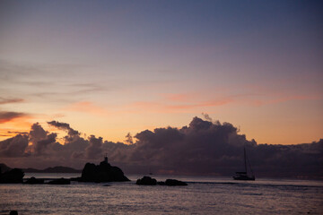 Wonderful Sunset over the sea with island in silhouette