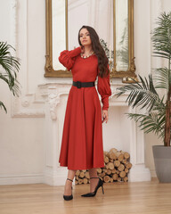 Beautiful caucasian woman wearing red sundress dress. Elegant female model with make-up and wavy...