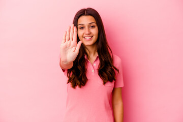 Fototapeta premium Young Indian woman isolated on pink background smiling cheerful showing number five with fingers.