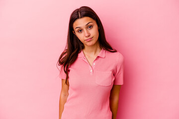 Young Indian woman isolated on pink background sad, serious face, feeling miserable and displeased.