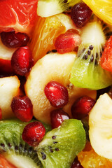 Fruit salad close-up in full screen, as a background.
