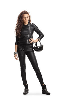 Full length portrait young of a woman with long curly hair holding a biker helmet