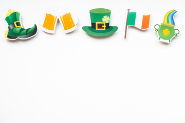 Shamrocks and St Patricks Day symbols on white background with copy space