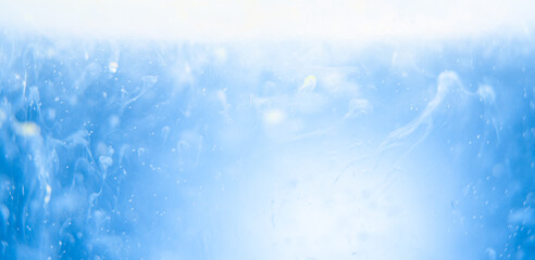 blue paint in water on background