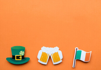 St Patricks Day symbols on orange background with copy space