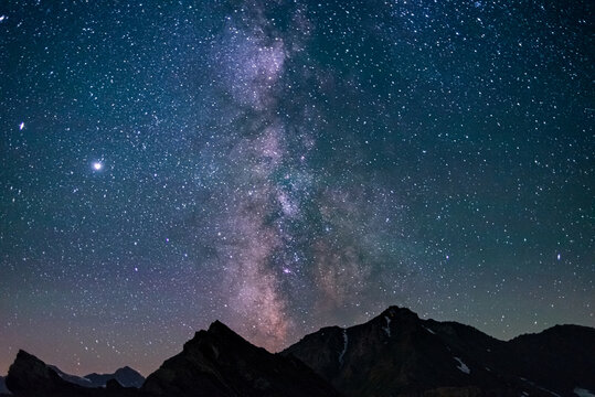 The Milky Way galaxy and the stars in the night sky view from high altitude mountain range, the Alps.