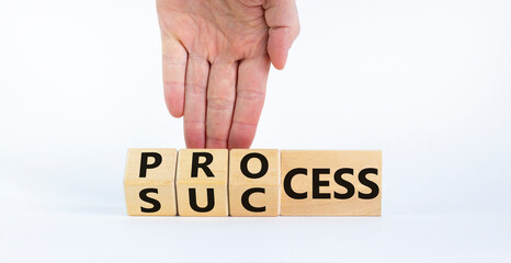 Success process symbol. Businessman turns wooden cubes and changes the word 'success' to 'process'. Beautiful white background, copy space. Business, success process concept.