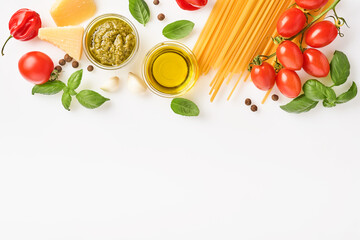 Spaghetti, fresh tomato, herbs and spices. Composition of healthy food ingredients isolated on white background, top view