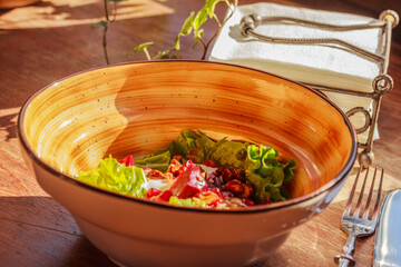 Healthy lunch in a restaurant or café.  Salad on wooden background . Life after Covid.  Side view, stock photo