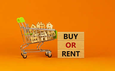 Buy or rent real estate symbol. Wooden blocks with words 'buy or rent' on beautiful orange...