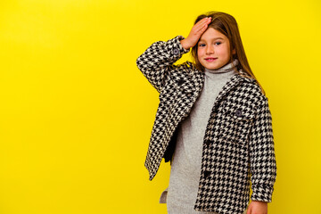 Little caucasian girl isolated on yellow background laughing happy, carefree, natural emotion.