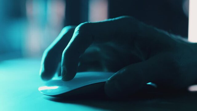 Using computer mouse in office at night, close up