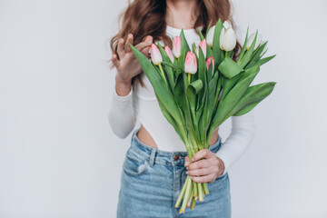 smiling woman with bouquet of spring tulips isolated on white