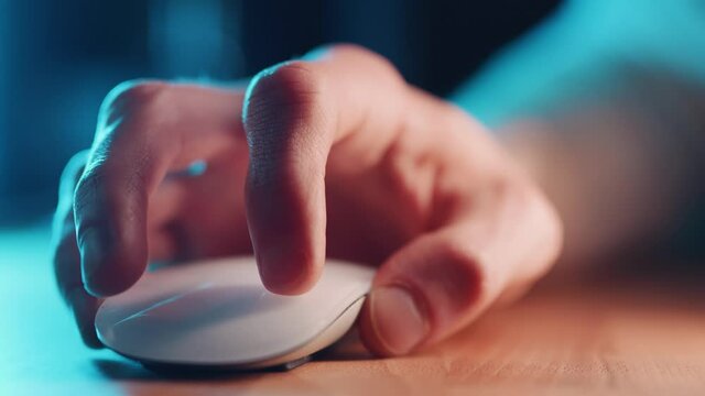 Using computer mouse in office at night, close up