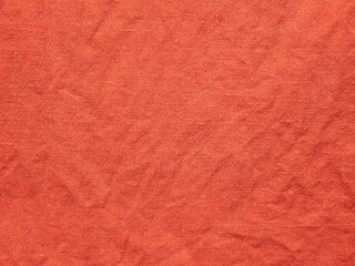 Wrinkled linen texture. Textured surface of red flax fabric