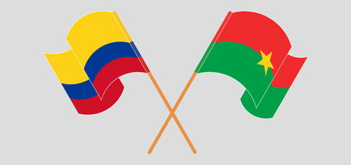 Crossed and waving flags of Burkina Faso and Colombia