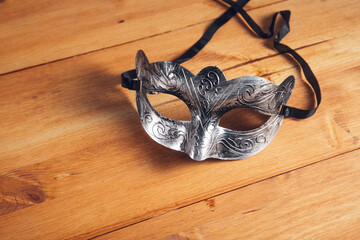 masquerade mask on a wooden table