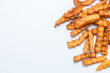 Fried, golden fries on white isolate. French fries as fast food.
