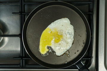 On the stove, a frying pan with scrambled eggs